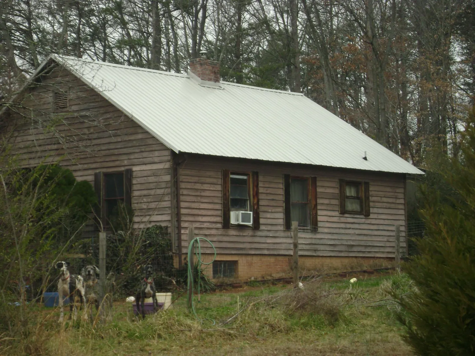White metal roof on an old wood sided farmhouse, from a Metal Roof Installation job in Bevington